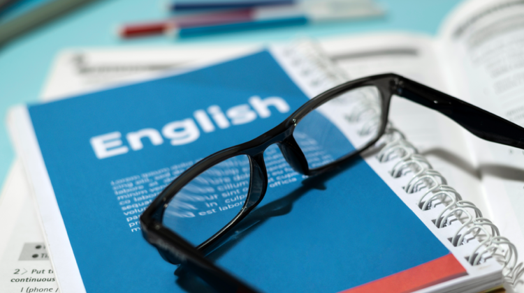 A pair of glasses on an English book.
